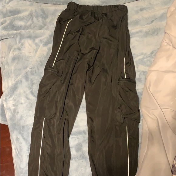 Mesh black pants with white stripe along the leg. - Picture 1 of 2